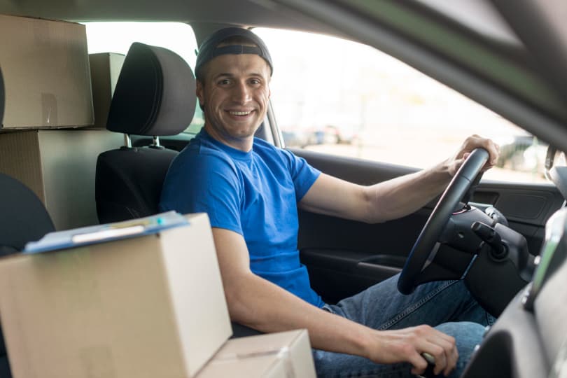 a-man-seated-in-the-drivers-seat-of-a-car